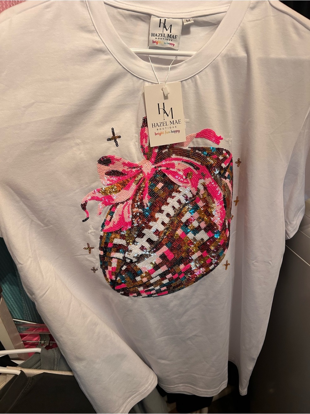 hazel Mae brand new White Tee with Sequin Football and Pink Bow Accent